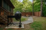Beautifully Landscaped Backyard with Fire Pit, Stonework & Egg Style Charcoal Grill